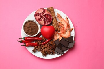 Natural aphrodisiac. Different products and heart model on pink background, top view
