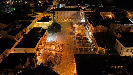 Aerial drone night shot of illuminated historic old city of Nafplio former capital of Greece,...