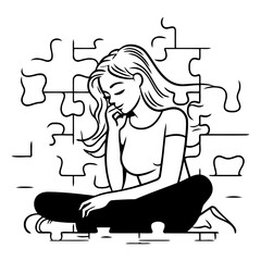 Sad woman sitting on the floor in front of a puzzle.