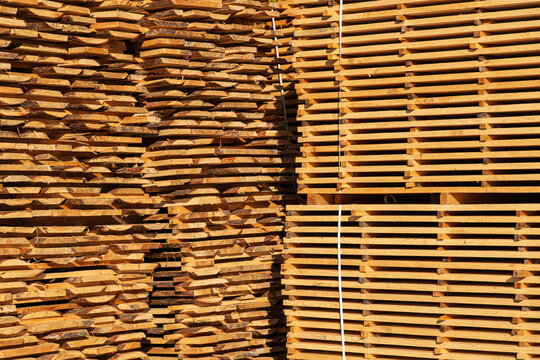Wooden timber at a sawmill. Piles of wooden boards in the sawmill. Sawmill plant