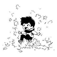 Little boy sitting on a pile of autumn leaves.