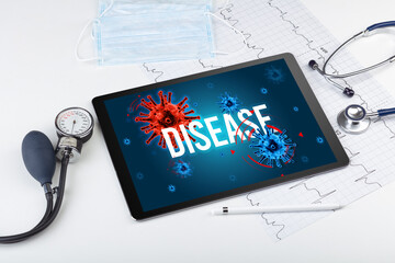 Tablet pc and doctor tools on white surface