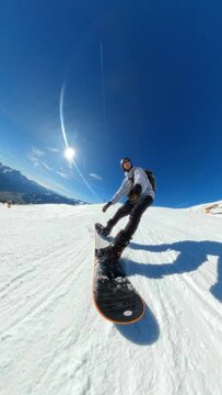 Vertical POV Footage of Man Snowboarding Down Mountain in Austria Alps using GoPro MAX on Blue Sunny Day