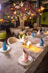 Elegant restaurant interior with decorated ceiling and table settings