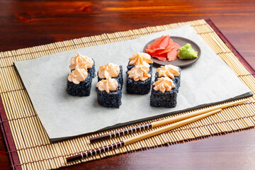 Sushi, black rice Lava rolls. Lunch. Japanese food.