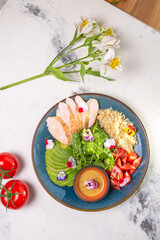 Healthy Lunch Plate With Grilled Chicken, Salad, Avocado, Couscous on Blue Plate