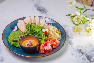 Healthy Lunch Plate With Grilled Chicken, Salad, Avocado, Couscous on Blue Plate