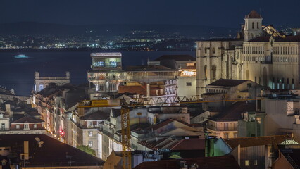 Fototapeta na wymiar Lisbon from above night timelapse: view of Baixa district with Santa Justa Lift and Convento da Ordem do Carmo church. Portugal