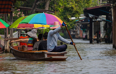 people on a floating market boat 
