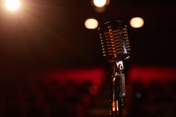 Still life of metal retro microphone on stage with spotlight copy space