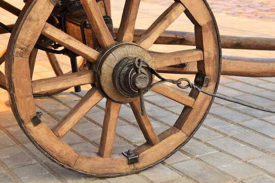 Wooden wheel of an antique cart close-up