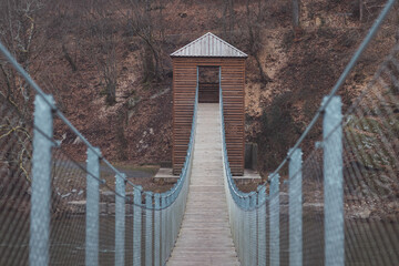 Walk on the wooden oval bridge over the river La semois in the wild countryside of the Walloon part of Belgium