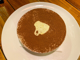 Cheese cake topped with tiramisu on plate