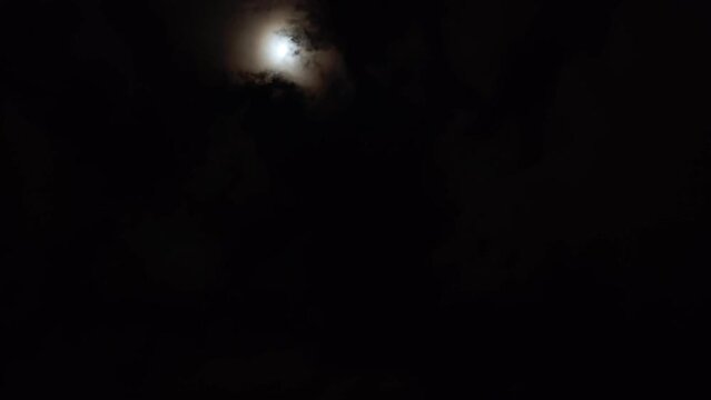 The clouds leave and the moon illuminates the dark sky