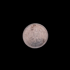 German Deutsche Mark coin on a black background.
