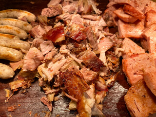 Various processed pork on a wooden cutting board