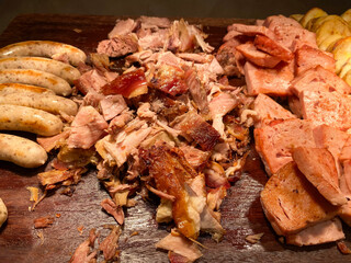 Various processed pork on a wooden cutting board