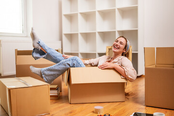 Happy woman having fun while moving into new apartment.	 - 765026321