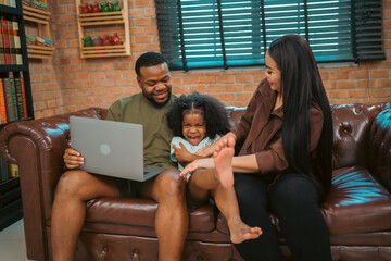 Smiling African-American father shares fun and love with his cheerful children at home, celebrating family with childhood together, African American black person in happy together of father's day - 765031549