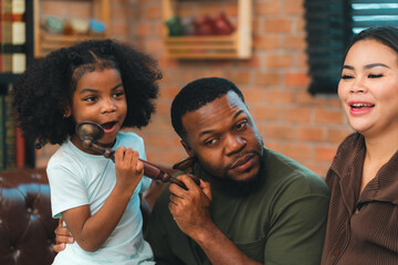 Smiling African-American father shares fun and love with his cheerful children at home, celebrating family with childhood together, African American black person in happy together of father's day - 765031580