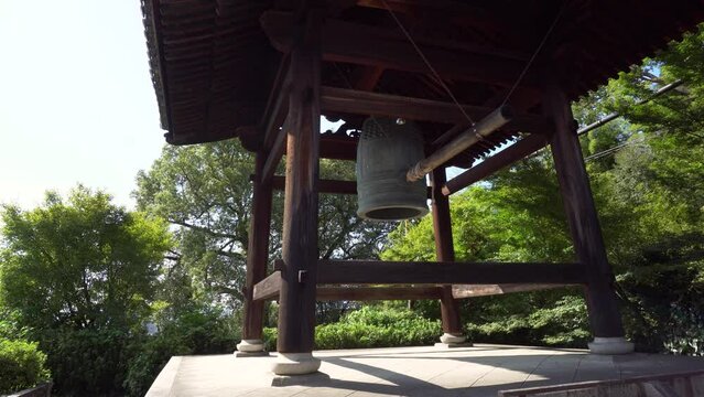 Bonsho Buddhist Bell and Shumoku inside Wooden Shoro at Temple in Kyoto, Japan