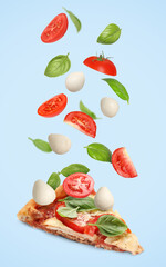 Caprese pizza and ingredients in air on light blue background