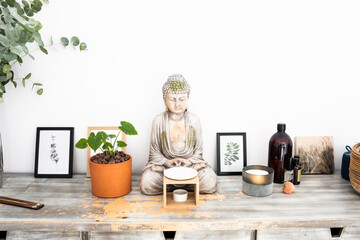Spa room for relaxation with scented candles and a Buddha figurine - obrazy, fototapety, plakaty