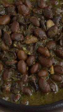 Black soybeans cooked in spices. Bhat ki Chudkani - a traditional dish of the Kumaon region. Table spin. Vertical video;
