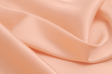 Beautiful smooth elegant wavy light peach orange satin silk luxury cloth fabric texture, abstract...