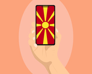 Macedonia flag on mobile phone screen, holding smartphone, advertising social media or banner concept