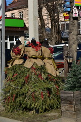 mannequins with jewelry and skirts made from thuja branches on a city street