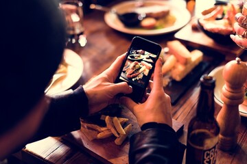 Fototapeta na wymiar Man Use Mobile Snap Food Photo