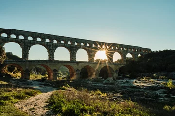 Papier Peint photo autocollant Pont du Gard illuminated ancient Roman aqueduct Pont du Gard near Languedoc, France, built as part of the infrastructure for water supply of the roman empire.