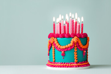 Elaborate frilled birthday cake with colorful vintage piping and birthday candles