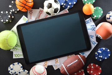Online sports betting with tablet in the center top view