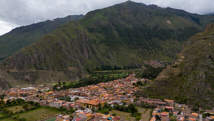 Fototapeta na wymiar Aerial Drone view of Ollantaytambo Inca city town in Peru mountains and Inca ruins