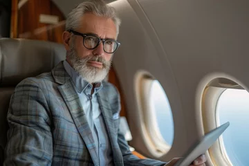 Photo sur Plexiglas Ancien avion Handsome middle aged businessman in suit using tablet in plane during business trip, Generative AI