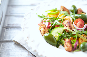 Healthy Salad with Chicken Breast, Cherry Tomatoes, Cucumber, Rocket and Green Olives. Close up.	