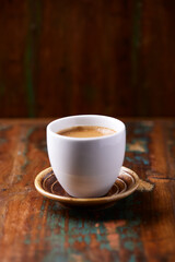 Cup of coffee on rustic wooden background. Copy space.