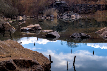 Stones and water in abandoned granite quarry