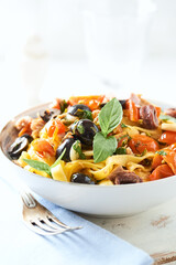 Spaghetti Pasta with Vegetables and fresh Basil on bright wooden Background	