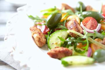 Healthy Salad with Chicken Breast, Cherry Tomatoes, Cucumber, Rocket and Green Olives. Close up.	