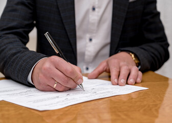 The groom signs the marriage certificate	