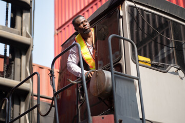 African logistic engineer man worker or foreman working and driver forklift container at container site	 - 765060372