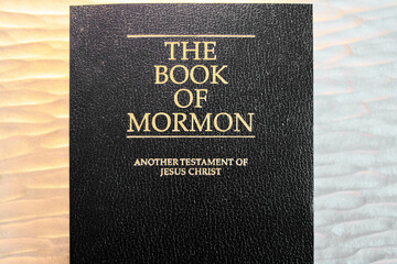 The ‘Book of Mormon’ shines with golden letters, inviting readers to explore its pages offering...