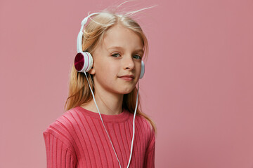 Happy Schoolgirl with Pink Headphones and Open Mouth Expressing Joy in a Stylish Studio Background