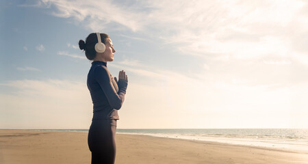 woman practicing yoga and meditating on the beach. Sport, Active life.