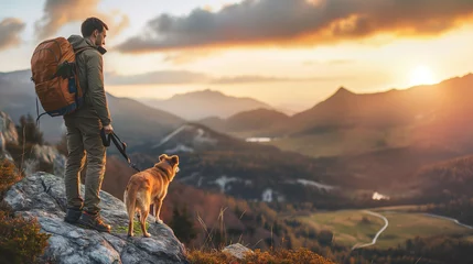 Fotobehang A hiker, a young man and his dog, hiking in beautiful rocky European Alps mountain landscape with a trekking backpack. A man hiking in the sunrise time. © Natalia Schuchardt