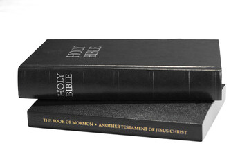 A close view of the sacred book of the Mormons, showing the embossed golden title on a textured black cover, symbolizing spirituality and faith.