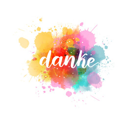 Danke - Thank you in German. Handwritten modern calligraphy watercolor lettering text. Colorful handlettering on watercolor paint splash